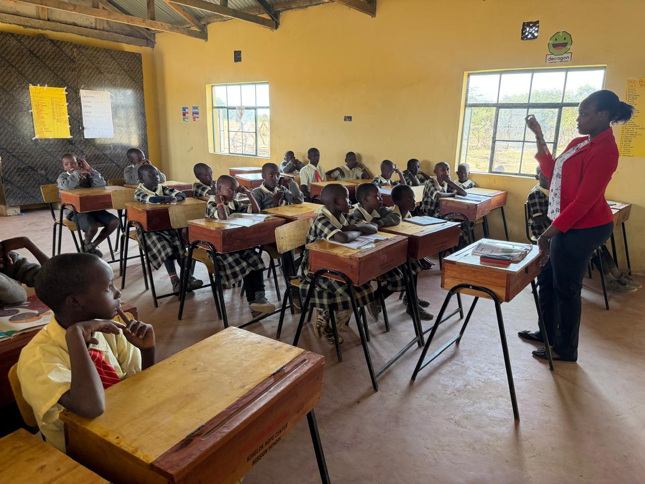 Children learning in a rural Kenyan classroom with warm natural light